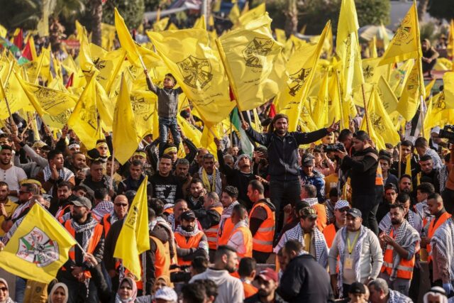 Fatah supporters wave their movement's yellow colours at a rare mass rally in the Hamas-co