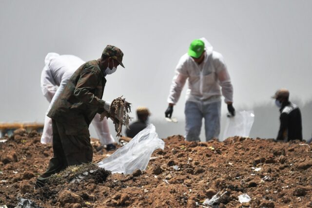 Forensics experts shown in March 2019 combing through the crash site of an Ethiopian Airli