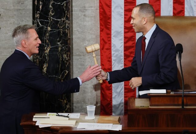 House Democratic leader Hakeem Jeffries (right) smiled as he handed the gavel to Kevin McC