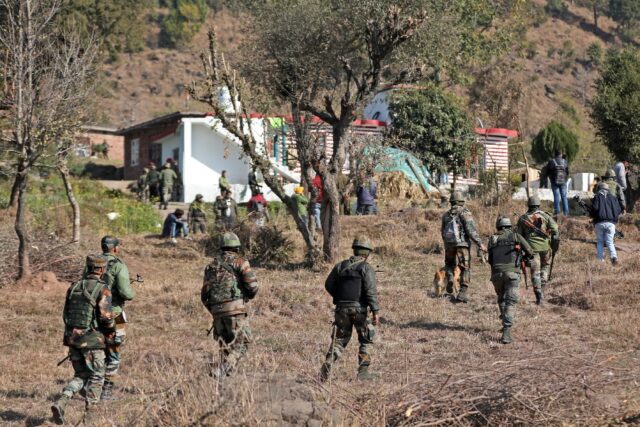 Indian soldiers conduct a search operation after gunmen opened fire on houses in the villa
