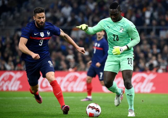 Ivory Coast goalkeeper Badra Sangare (R) clears the ball in a friendly against France on M