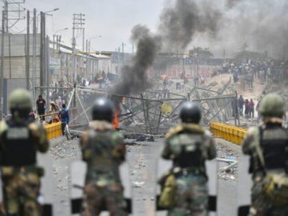 Members of the Peruvian security forces face off with protesters on a bridge near the airport in the southern city of Arequipa on January 20, 2023