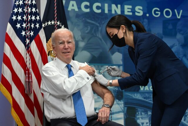 US President Joe Biden receives a Covid-19 booster shot in the South Court Auditorium of t