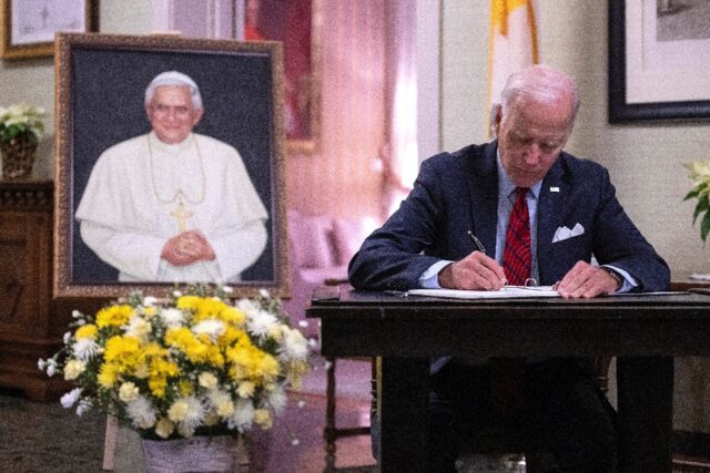 US President Joe Biden signs the condolence book for former pope Benedict XVI at the Vatic