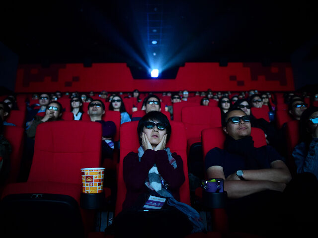 This picture taken on April 27, 2018 shows people watching a movie at a cinema in Wanda Group's Oriental Movie Metropolis in Qingdao, China's Shandong province. - A massive "movie metropolis" billed as China's answer to Hollywood opened on April 28, aiming to boost the domestic film industry and attract …
