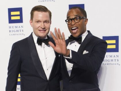Nick Schmit, left, and husband Jonathan Capehart, Pulitzer Prize-winning opinion writer for The Washington Post, pose for photographerss upon arriving at the Human Rights Campaign National Dinner in Washington, Saturday, Sept. 15, 2018. (AP Photo/Cliff Owen)