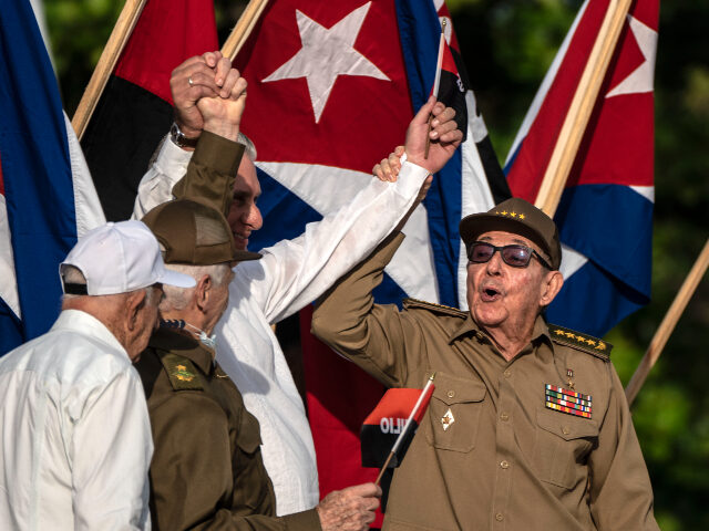 Former Cuban President Raul Castro, right, raises the hand of Cuban President Miguel Diaz-