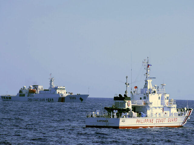 In this photo provided by the Philippine Coast Guard, a Chinese Coast Guard ship sails near a Philippine Coast Guard vessel during its patrol at Bajo de Masinloc, 124 nautical miles west of Zambales province, northwestern Philippines on March 2, 2022. The Philippines has sought an explanation from China after …