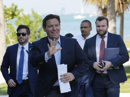 Florida Gov. Ron DeSantis waves as he arrives for a news conference at Bill Baggs Cape Flo