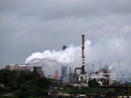 FILE - Steam emits from a crude oil refinery in Kochi, Kerala state, India, on Aug. 26, 20
