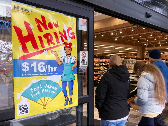A hiring sign is displayed at a grocery store in Arlington Heights, Ill., Friday, Jan. 13,