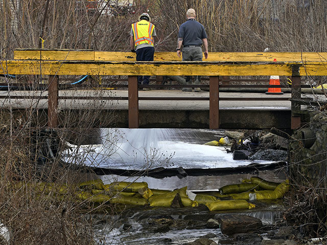 HEPACO workers observe a stream in East Palestine, Ohio, Thursday, Feb. 9, 2023 as the cleanup continues after the derailment of a Norfolk Southern freight train Friday. (AP Photo/Gene J. Puskar)