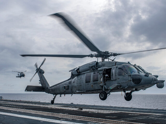 An MH-60S Sea Hawk helicopter lands aboard the aircraft carrier USS Nimitz in the South China Sea, Sunday, Feb. 12, 2023, as Nimitz in U.S. 7th Fleet was conducting operations. The 7th Fleet based in Japan said Sunday that the USS Nimitz aircraft carrier strike group and the 13th Marine …