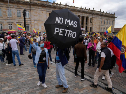 Anti-government protesters demonstrate against proposed reforms in Bogota, Colombia, Wednesday, Feb. 15, 2023. The umbrella reads in Spanish "No more Petro," referring to Colombian President Gustavo Petro. (AP Photo/Fernando Vergara)