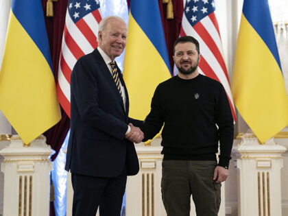 US President Joe Biden, left, shakes hands with Ukrainian President Volodymyr Zelenskyy at
