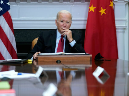 FILE - President Joe Biden listens as he meets virtually with Chinese President Xi Jinping from the Roosevelt Room of the White House in Washington, Monday, Nov. 15, 2021. Just 40% of U.S. adults approve of how President Joe Biden is handling relations with China, a new poll shows, with …
