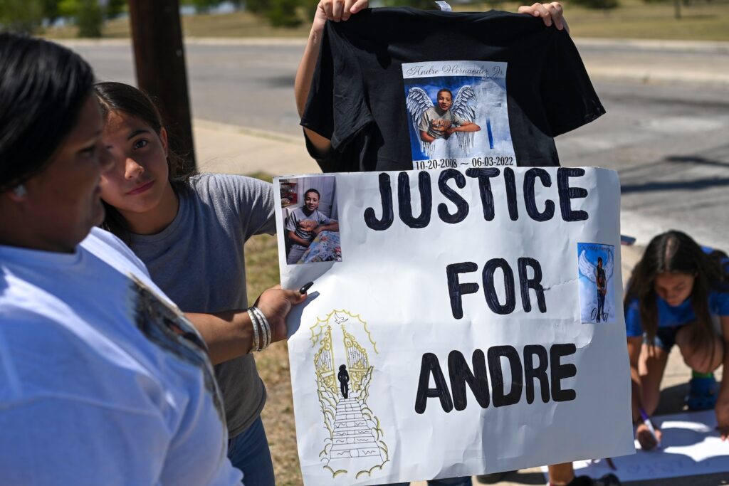 SAN Antonio ,TX - JUNE 11: Friends and family members of 13-year-old Andre Hernandez hold signs outside Millers Pond Park as they try to attract motorists to a food plate sale to raise money for Hernandezs funeral on June 11, 2022 in San Antonio, Texas. Hernandez was fatally wounded by a San Antonio police officer earlier month. Police tried to stop Hernandez in a stolen vehicle he was driving when he accelerated towards an officers vehicle. Hernandezs 16-year-old sister Navaho Martinez was shot and killed last month as she sat inside a vehicle near her home. (Photo by Joshua Lott/The Washington Post via Getty Images)