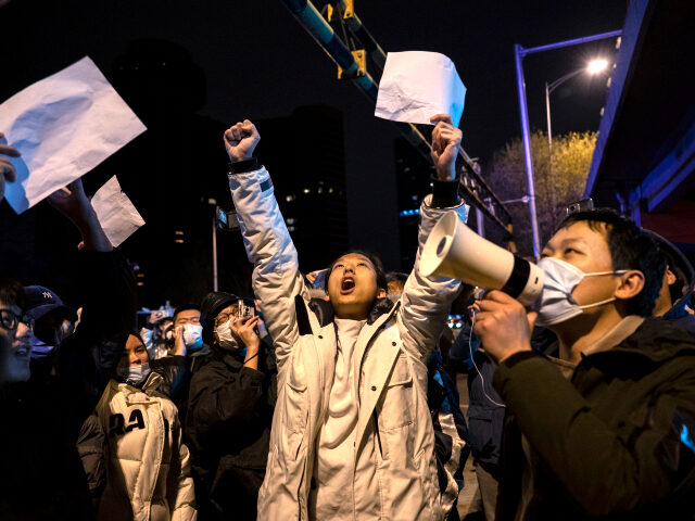 BEIJING, CHINA -NOVEMBER 28: Protesters shout slogans during a protest against China’s strict zero COVID measures on November 28, 2022 in Beijing, China. Protesters took to the streets in multiple Chinese cities after a deadly apartment fire in Xinjiang province sparked a national outcry as many blamed COVID restrictions for …