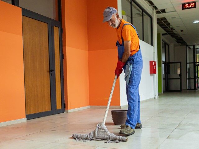 Custodian cleans floor