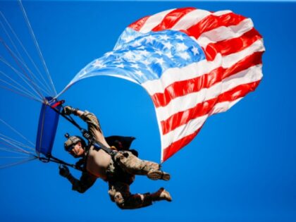 KANSAS CITY, MO - SEPTEMBER 23: A skydiver with the American Flag in tow jumps to the field halftime of the game between the Kansas City Chiefs and the San Francisco 49ers at Arrowhead Stadium on September 23rd, 2018 in Kansas City, Missouri. (Photo by David Eulitt/Getty Images)