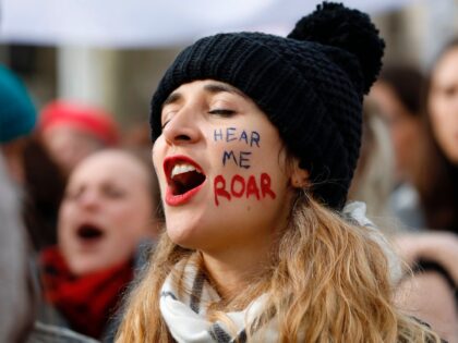 A woman shouts slogans as demonstrators attend the "March4Women" during the International Women's Day in London on March 8, 2020. - Many feminist groups held online campaigns instead of street marches, using hashtags such as #FemaleStrike, #PowerUp and #38InternationalWomensDay to raise awareness of gender inequality. (Photo by Tolga AKMEN / …