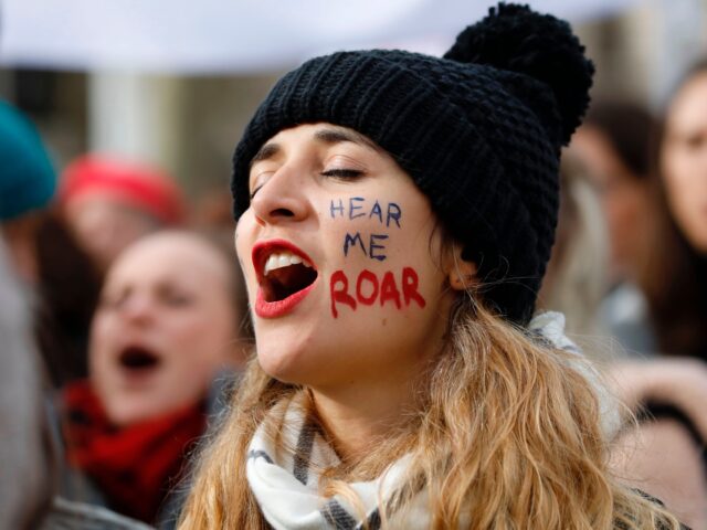 A woman shouts slogans as demonstrators attend the "March4Women" during the International