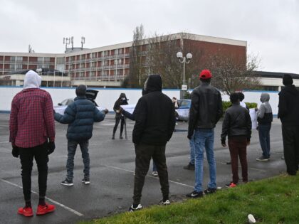 Asylum seekers being housed at the Crowne Plaza hotel as they wait for their asylum claims to be processed, protest their living conditions and the length of time the claims process is taking, outside the hotel at Heathrow in west London, on February 16, 2021. (Photo by JUSTIN TALLIS / …