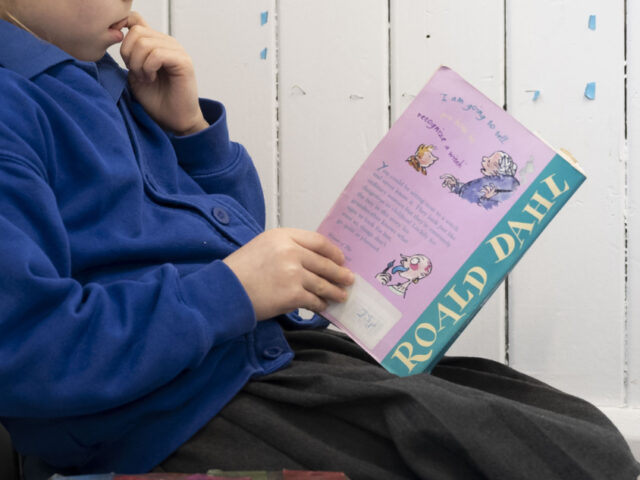 CARDIFF, WALES - FEBRUARY 23: A child reads a Roald Dahl book at Roath Park Primary School