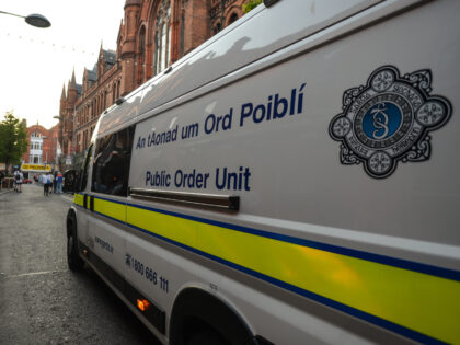 Members of Gardai (Irish Police) enforce coronavirus restrictions and relocate people from