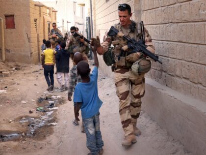 French soldiers of the Barkhane force patrol the streets of Timbuktu, northern Mali, on De