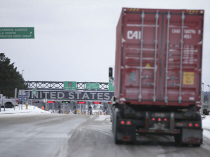 A truck heads into the U.S. at the border in St-Bernard-de-Lacolle, Quebec, Canada, on Friday, Jan. 14, 2021. Canada plans to start turning away unvaccinated U.S. truckers at the border this weekend, a move that threatens to upend the flow of everything from food to auto parts to building supplies …