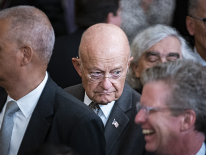 James Clapper, former director of national intelligence, center, following a ceremony with former US President Barack Obama and former First Lady Michelle Obama for the unveiling of their official White House portraits in Washington, D.C., US, on Wednesday, Sept. 7, 2022. The portraits of Barack Obama and Michelle Obama, acquired …