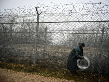 Workers repair the barbed wire wall border fence on the Bulgaria-Turkey border near the village of Lesovo on January 13, 2023. (Photo by Nikolay DOYCHINOV / AFP) (Photo by NIKOLAY DOYCHINOV/AFP via Getty Images)
