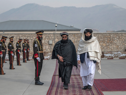 Minister of Interior affairs of Afghanistan, Sirajuddin Haqqani (R) arrives to attend an i