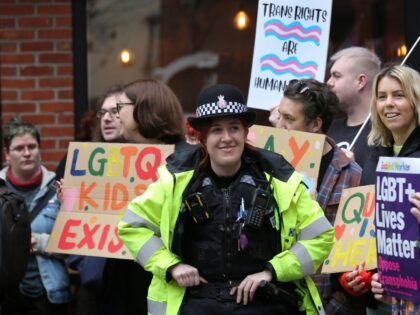 COLCHESTER, ENGLAND - FEBRUARY 04: Police officers keep an eye on the gathering as supporters of Drag Queen Story Hour hold signs of support outside the library on February 4, 2023 in Colchester, England. The library readings have been controversial in the past, with disruptive protests leading to a number …