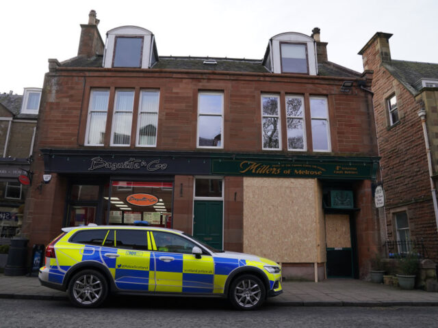 A police car parked outside Millers of Melrose, a family butchers shop which has been boar