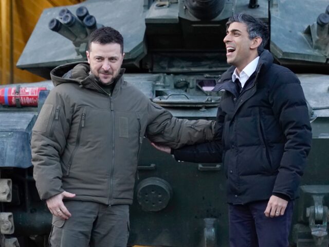 LULWORTH, UNITED KINGDOM - FEBRUARY 8: Prime Minister Rishi Sunak and Ukrainian President Volodymyr Zelensky meet Ukrainian troops being trained to command Challenger 2 tanks at a military facility on February 8, 2023 in Lulworth, Dorset, England. The Ukrainian President makes a surprise visit to the UK today in his …
