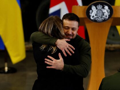 DORSET, ENGLAND - FEBRUARY 08: Ukrainian President, Volodymyr Zelensky hugs a BBC Ukraine journalist, while at a news conference with British Prime Minister Rishi Sunak (not pictured) at an army camp on February 8, 2023 in Dorset, England. The Ukrainian President makes a surprise visit to the UK today in …
