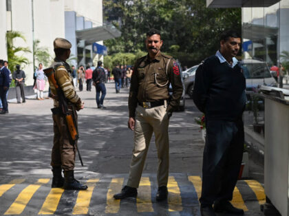 A police officer (C) stands at the entrance of the office building where Indian tax authorities raided BBC's office in New Delhi on February 14, 2023. - Indian tax authorities on February 14 raided the BBC's New Delhi office, a journalist at the broadcaster told AFP, weeks after it aired …