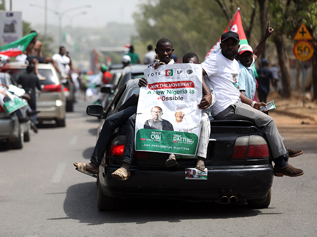 A supporter of Nigerias Labour Party, displays a banner during a global march for the pres