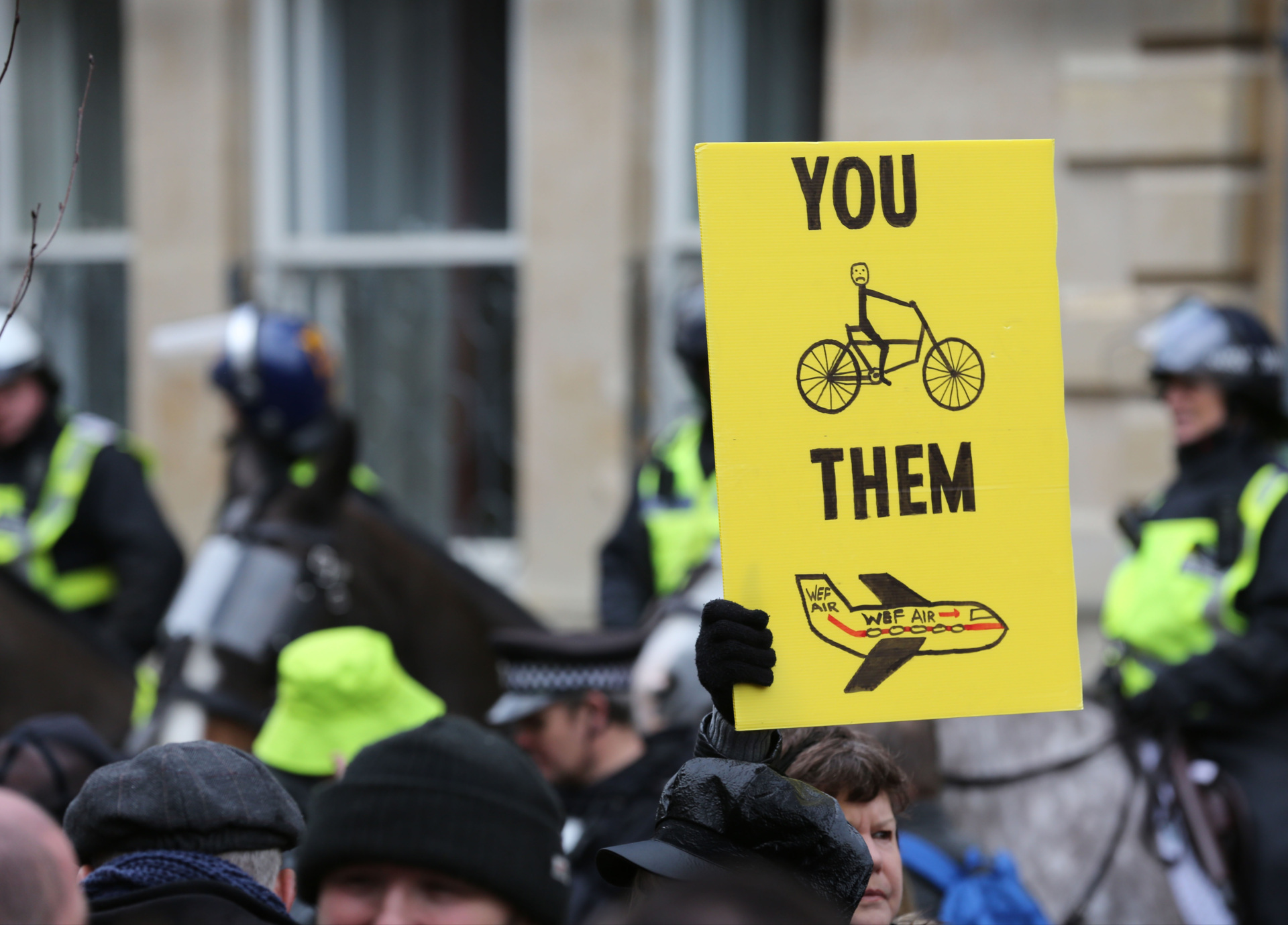 OXFORD, ENGLAND - FEBRUARY 18: A protester holds a sign criticizing the inequality of 15 minute cities as protesters gather at Broad Street on February 18, 2023 in Oxford, England.  The 15-minute cities concept suggests that all services, amenities, work and leisure are within a 15-20 minute walk or bike ride from a person's front door.  The protesters argue that the measures will turn areas into ghettos and limit their freedom of movement.  Car trips are restricted at certain times of the day and monitored with Number Plate Recognition Cameras (ANPR) and fines.  (Photo by Martin Pope/Getty Images)