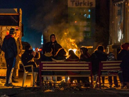 People of Reyhhanli, a turkish city in the border with Syria, get warm with fires in the streets after a fast evacuation from their homes because a 6,3 magnitude earthquake in Hatay region, Turkey. (Photo by Celestino Arce/NurPhoto via Getty Images)