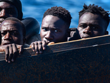 LAMPEDUSA, ITALY - 2023/02/21: Migrants stare blankly from a precarious metal boat carrying 40-50 migrants across the Mediterranean from Africa. At around 7:30 a.m. on Tuesday, 21 February, 40 sub-Saharan migrants were rescued from a precarious metal boat. There were 20 minors onboard, 18 of whom were unaccompanied by adults. …