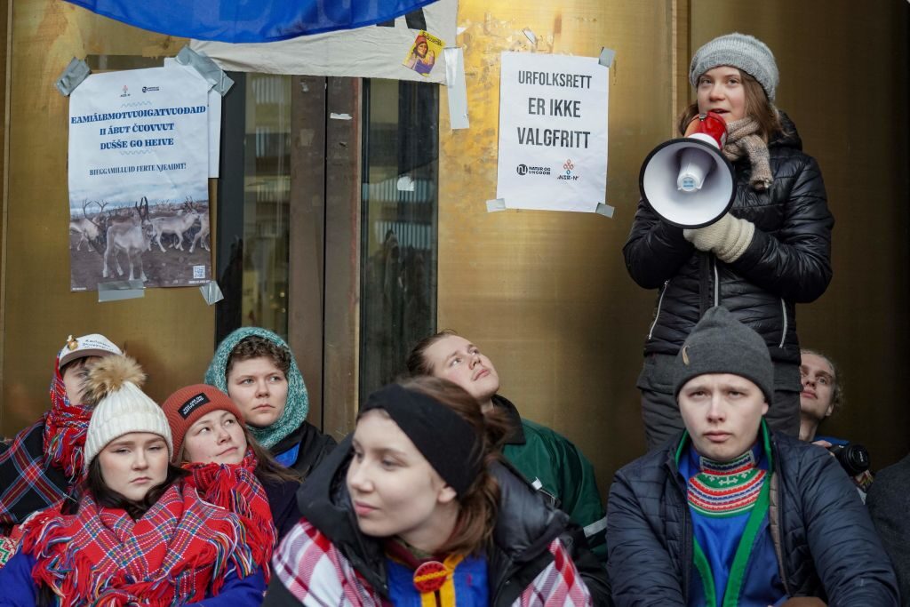 Sweden's Greta Thunberg (R) and other young climate activists from the "Nature and Youth" and "Norwegian Samirs Riksforbund Nuorat" groups block the entrance of Norway's Energy ministry as they protest against wind turbines built on land traditionally used to her reindeer, in Oslo, on February 27, 2023 (Photo by Ole Berg-Rusten / NTB / AFP) / Norway OUT (Photo by OLE BERG-RUSTEN/NTB/AFP via Getty Images)