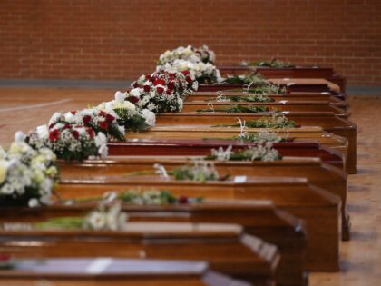 A photograph taken on February 28, 2023 shows the coffins of the migrants who died two days day before, after their boat sank off Italy's southern Calabria region, at the Crotone Palasport, the funeral home for the victims, in Steccato di Cutro, south of Crotone. - The death toll from …