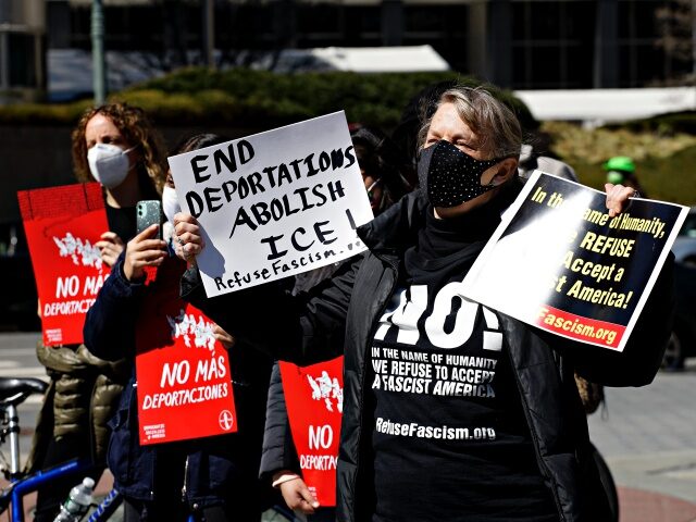 NEW YORK - NEW YORK - MARCH 20: A woman holds a placards during a protest against deportat