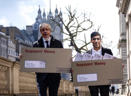LONDON, ENGLAND - APRIL 21: Labour Party campaigners on Whitehall during a stunt in which they carried envelopes labelled "Taxpayer's Money" while dressed as Chancellor of the Exchequer Rishi Sunak, Prime Minister Boris Johnson, Health Secretary Matt Hancock, and former Prime Minister David Cameron, on April 21, 2021 in London, …