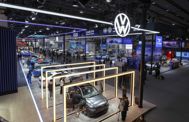 GUANGZHOU, CHINA - DECEMBER 30: People visit the Volkswagen stand during the 20th Guangzho