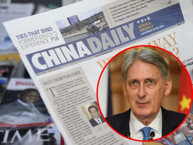 A newspaper consumer reads a copy of China's Africa edition of its daily newspaper infront