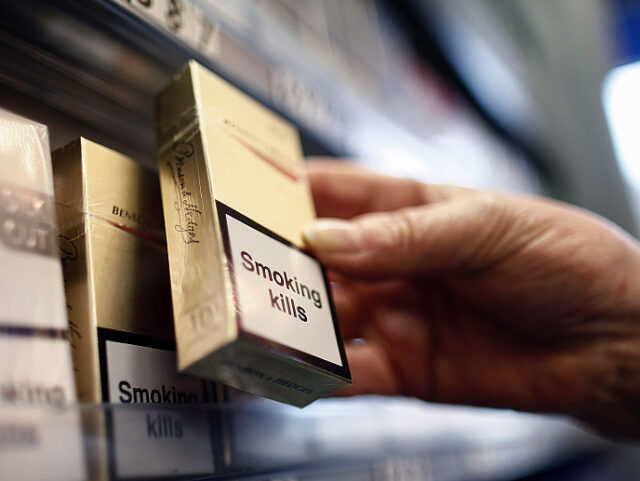 A "Smoking Kills" label sits on a packet of Benson and Hedges cigarettes, produc